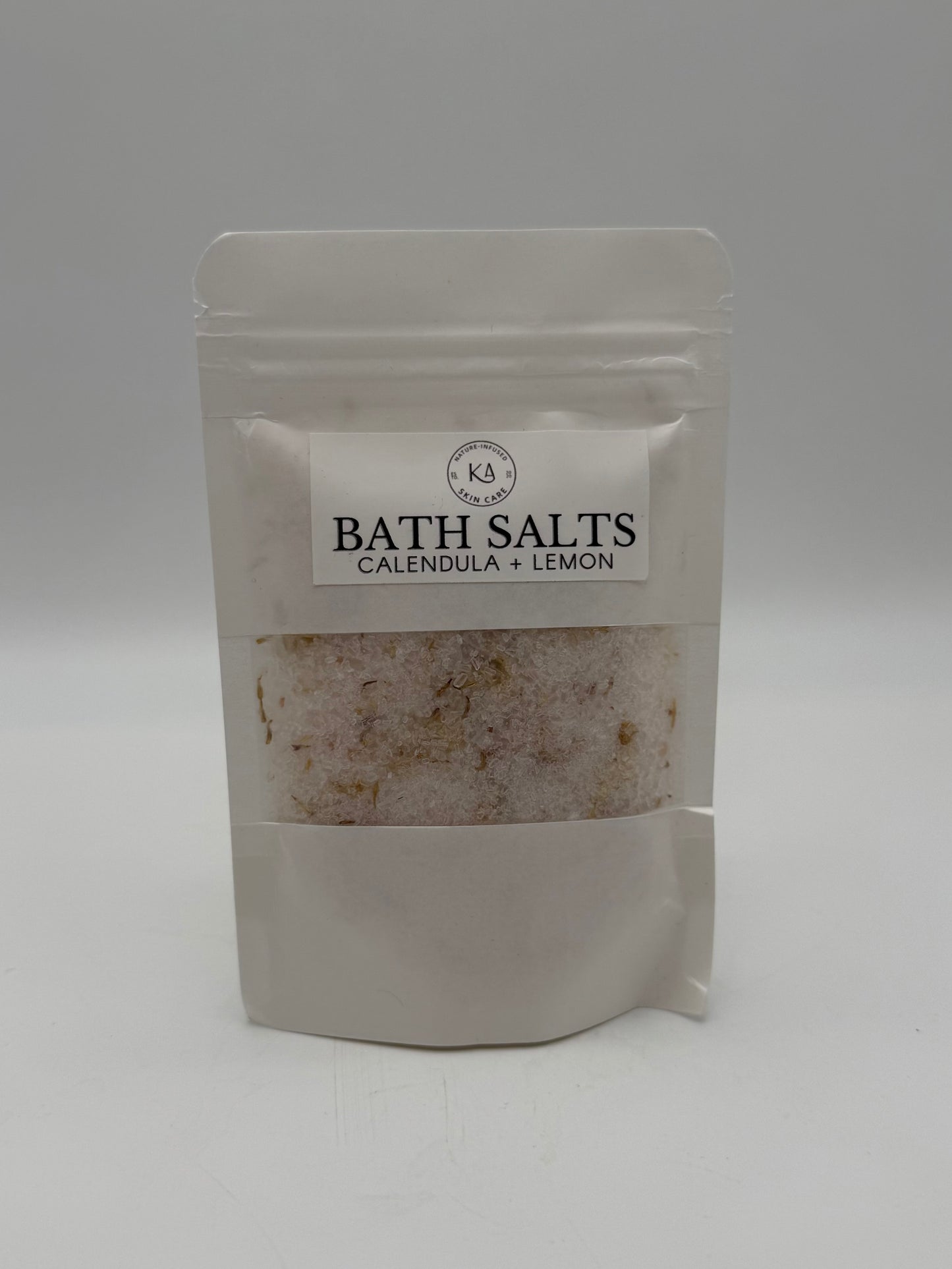Package of bath salts with a visible brand label on a white background