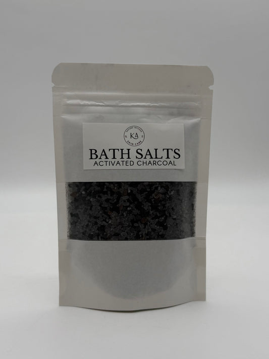 Package of bath salts with activated charcoal on a white background