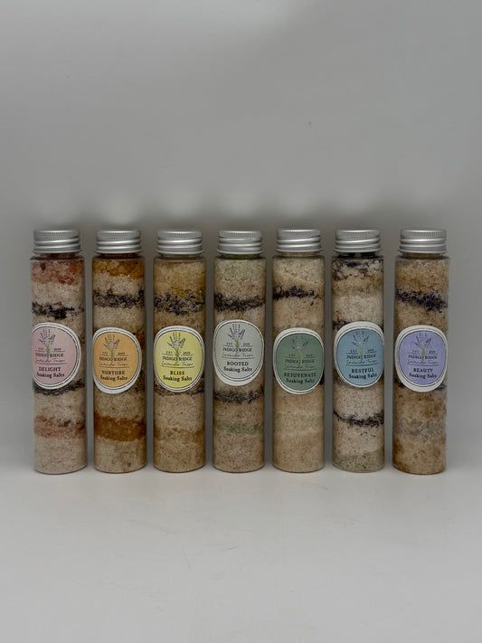 Row of cylindrical containers of layered bath salts from Indigo Ridge