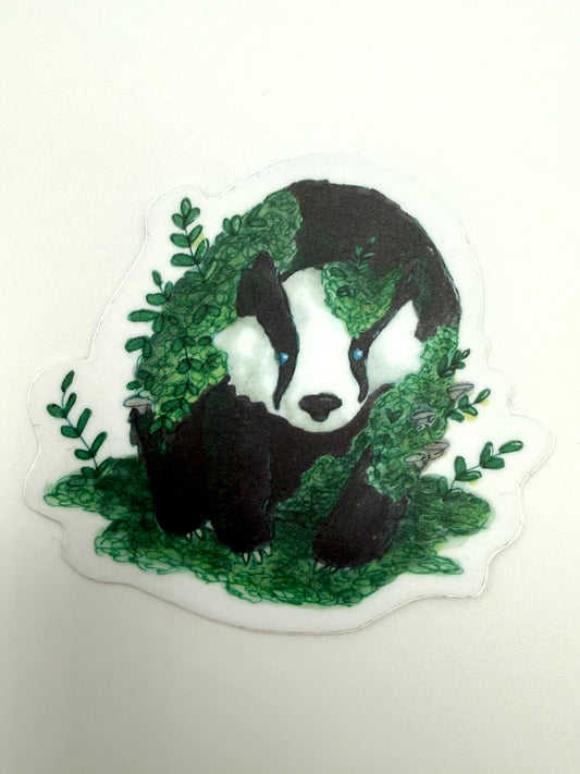 Sticker of a badger surrounded by green leaves on a white background