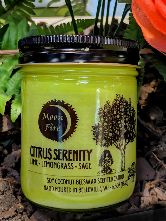 Green candle jar labeled 'Citrus Serenity' with 'Moon Fire' branding on a natural background.